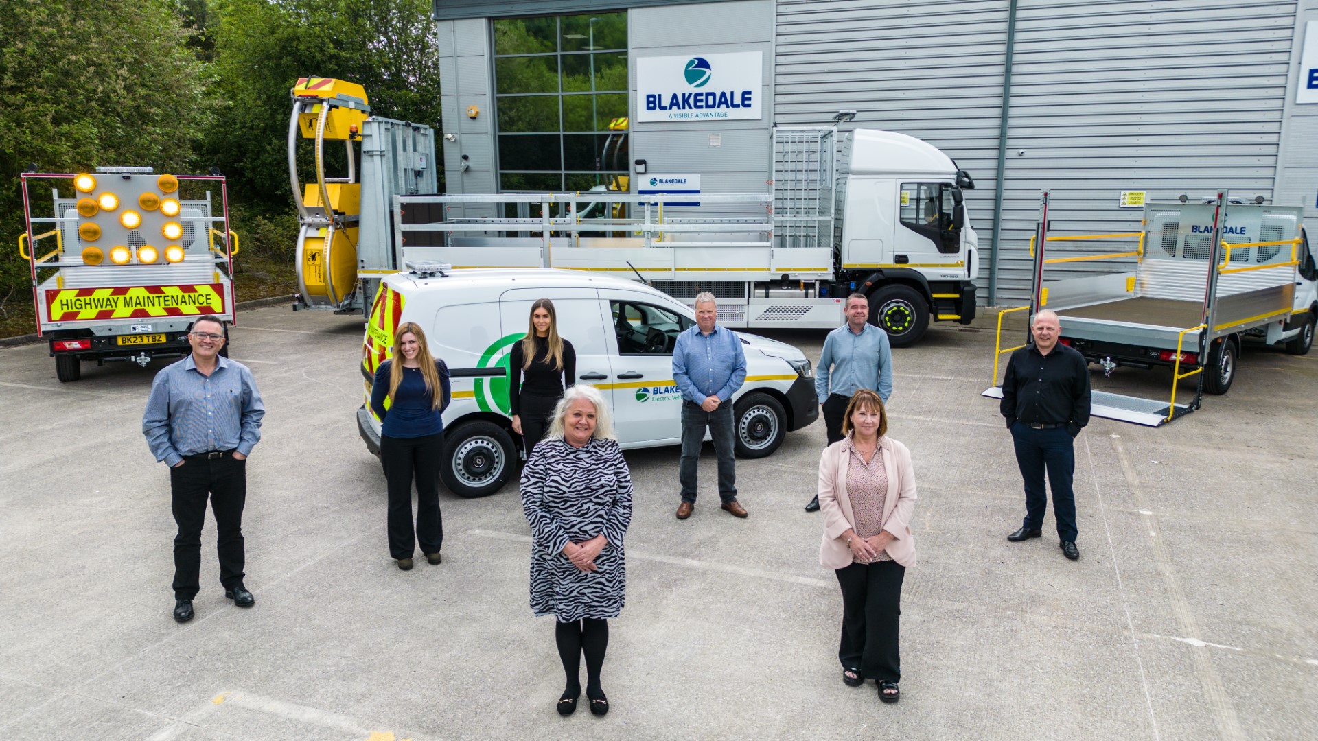 Sales, customer service and operation team with traffic management vehicle at Blakedale head office